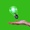 Human hand holding a shining electric bulb