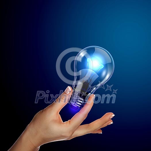 Human hand holding a shining electric bulb Human hand holding a shining electric bulb