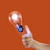 Human hand holding a shining electric bulb
