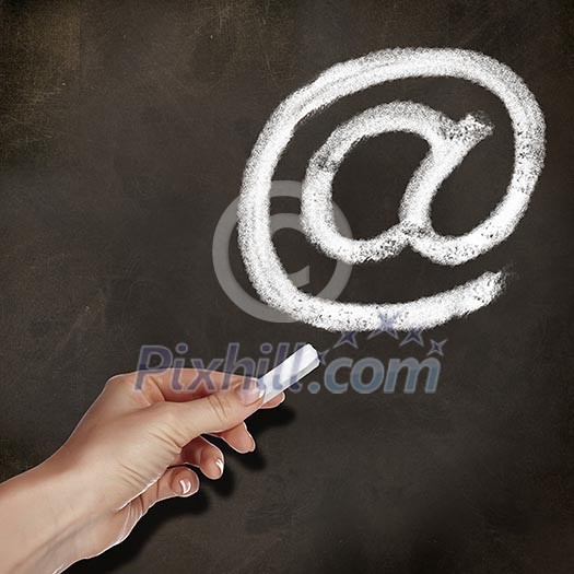 School blackboard and hand with chalk drawing email symbol School blackboard and hand with chalk drawing email symbol