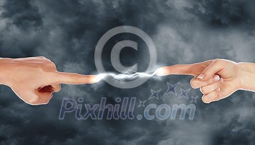Two human hands in contact with bright flash Two human hands in contact with bright flash