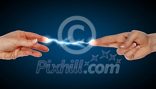 Two human hands in contact with bright flash Two human hands in contact with bright flash