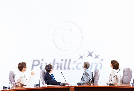 Image of businesspeople at presentation looking at screen. Space for advertisment Image of businesspeople at presentation looking at screen. Space for advertisment