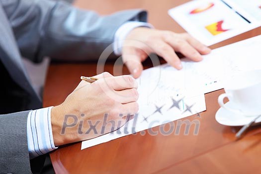 Image of businessman's hands signing documents at meeting Image of businessman's hands signing documents at meeting