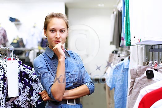 Young girl in a shop buying clothes Young girl in a shop buying clothes