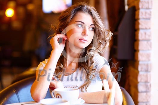 Portrait of young pretty woman sitting in restaurant Portrait of young pretty woman sitting in restaurant