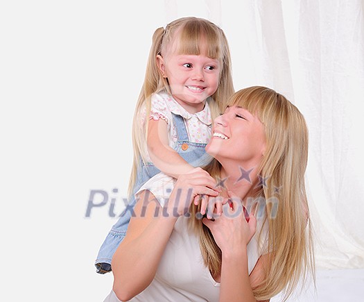 The little girl and her mother together having fun The little girl and her mother together having fun