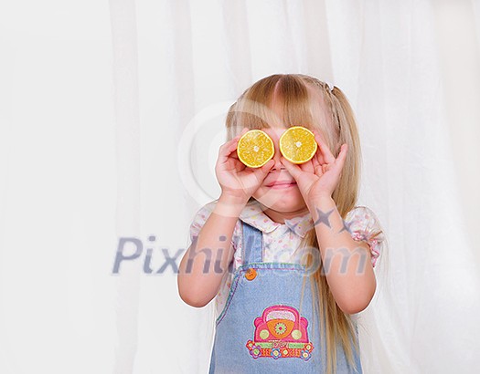 Portrait of a little girl with fruit in their hands. Portrait of a little girl with fruit in their hands.