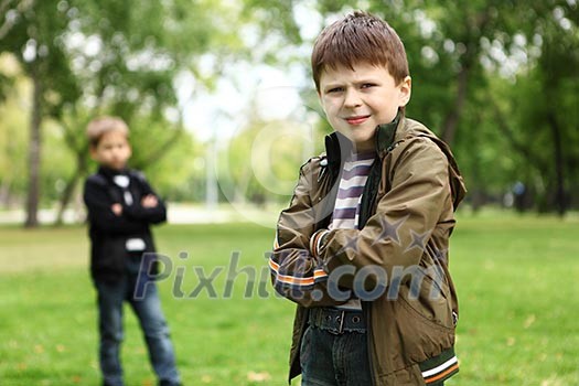 Happy smiling boy with a friend in the green park Happy smiling boy with a friend in the green park