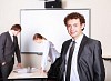 a young smiling businessman in formal wear in office