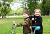 Happy smiling boy on a bicycle in the green park