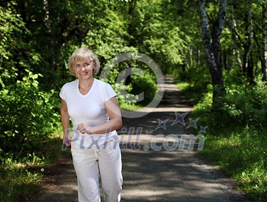 Elderly woman likes to run in the park. Healthy lifestyle