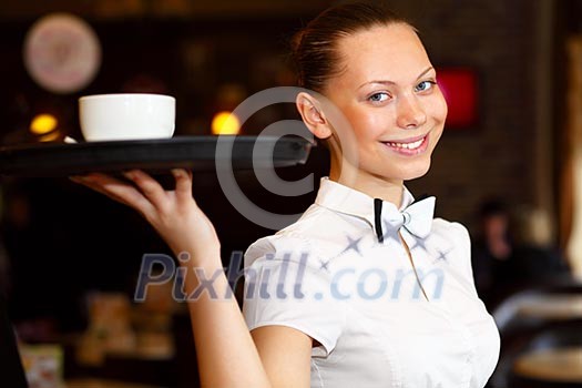 Portrait of young waitress in white blouse holding a tray Portrait of young waitress in white blouse holding a tray