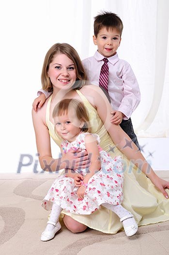 Mom, her son and her little daughter together having fun Mom, her son and her little daughter together having fun