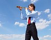 young business man in a blue shirt and red tie against the blue sky looks through a telescope. a symbol of leadership, success and freedom.