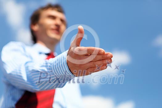 young businessman in a blue shirt and red tie giving a hand for a handshake young businessman in a blue shirt and red tie giving a hand for a handshake