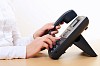 Hands of a young girl on the phone dials the number
