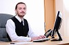 A young business man working on the computer in the office.
