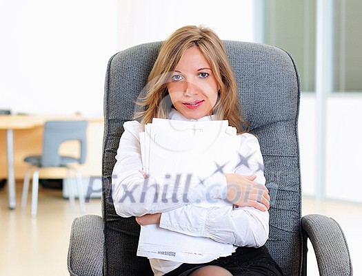 A young girl in his office sits in a gray chair. A young girl in his office sits in a gray chair.