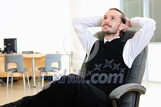 A business man in his office rests in the chair. A business man in his office rests in the chair.