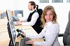 A young girl in his office at his workplace works at the computer