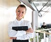 portrait of a young pretty woman standing inside office building