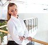 portrait of a young pretty woman standing inside office building