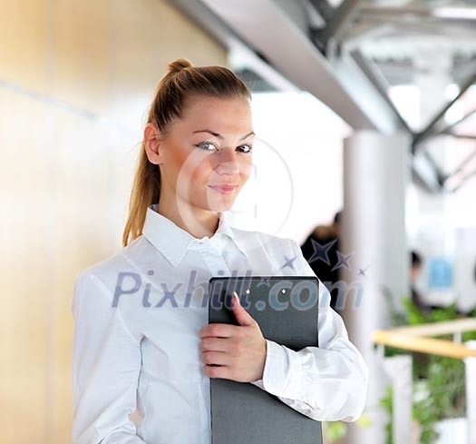 portrait of a young pretty woman standing inside office building portrait of a young pretty woman standing inside office building