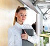 portrait of a young pretty woman standing inside office building