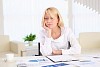 portrait of a young business woman with papers in the offcie