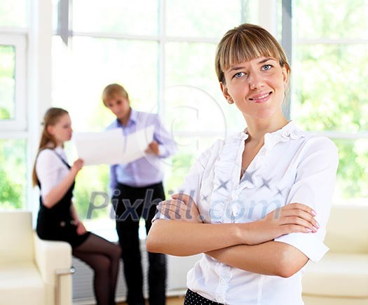 business woman in office and collegues on background business woman in office and collegues on background