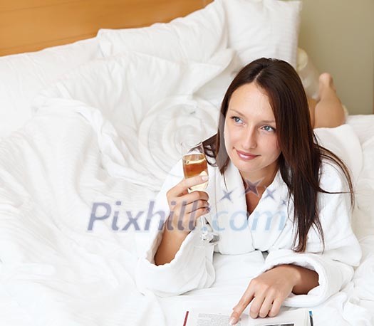 young woman with glass of champagne wearing bathrobe young woman with glass of champagne wearing bathrobe