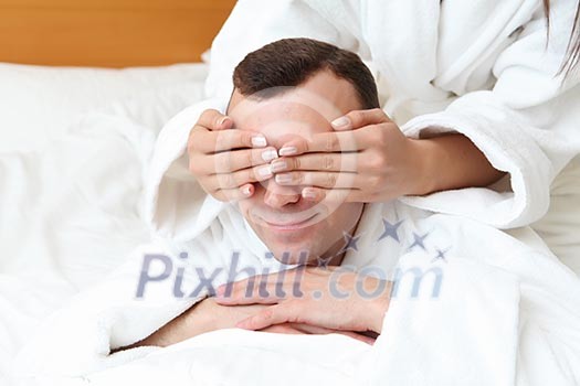 young man in bed with his eyes closed by woman young man in bed with his eyes closed by woman