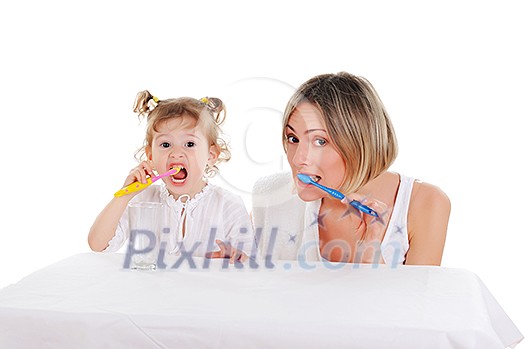 young mother and her young daughter brush their teeth on a white background young mother and her young daughter brush their teeth on a white background
