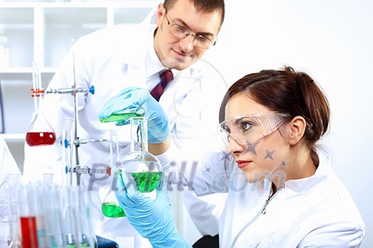 Scientist in uniform doing tests in laboratory Scientist in uniform doing tests in laboratory