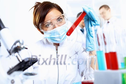 Scientist in uniform doing tests in laboratory Scientist in uniform doing tests in laboratory