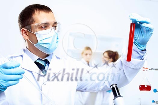 Scientist in uniform doing tests in laboratory Scientist in uniform doing tests in laboratory