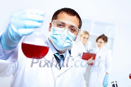 Scientist in uniform doing tests in laboratory Scientist in uniform doing tests in laboratory