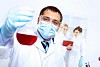Scientist in uniform doing tests in laboratory