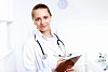 Friendly young female doctor in uniform in medical office