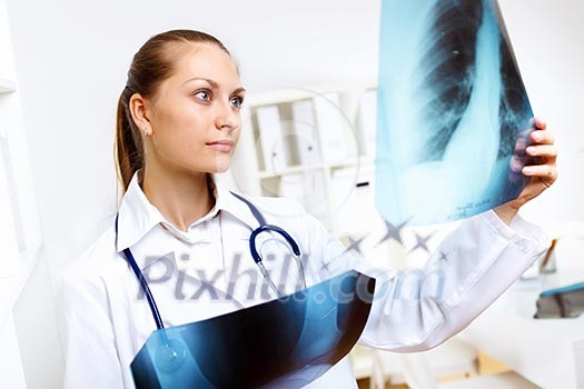 Friendly young female doctor in uniform in medical office Friendly young female doctor in uniform in medical office