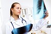 Friendly young female doctor in uniform in medical office