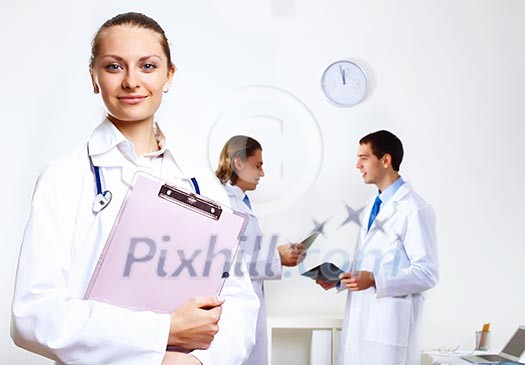 Friendly young female doctor in uniform in medical office Friendly young female doctor in uniform in medical office