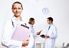 Friendly young female doctor in uniform in medical office