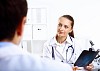 Friendly young female doctor in uniform in medical office