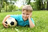 Little boy in the summer park with a ball