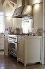 White kitchen block with steel oven and cooker hood