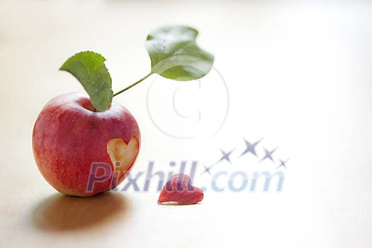Heart shape cut out of an apple Heart shape cut out of an apple