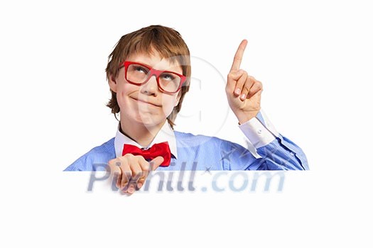 Image of young boy smiling thoughtfully holding white square. Place for advertisement Image of young boy smiling thoughtfully holding white square. Place for advertisement