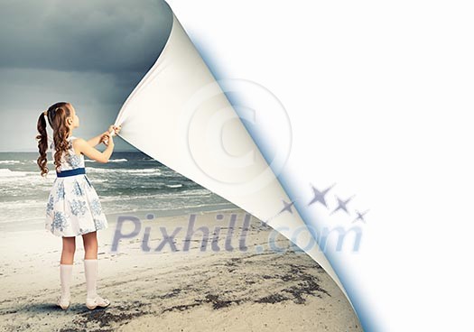 Little girl turning page with another reality Little girl turning page with another reality
